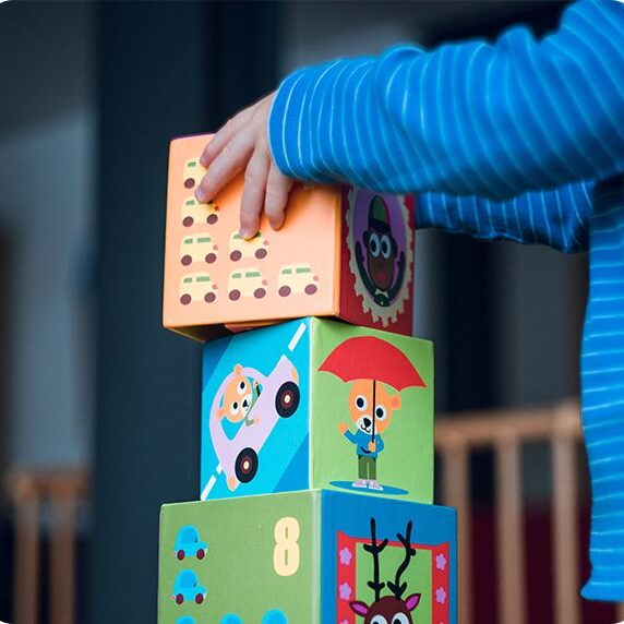 a kid stacking blocks