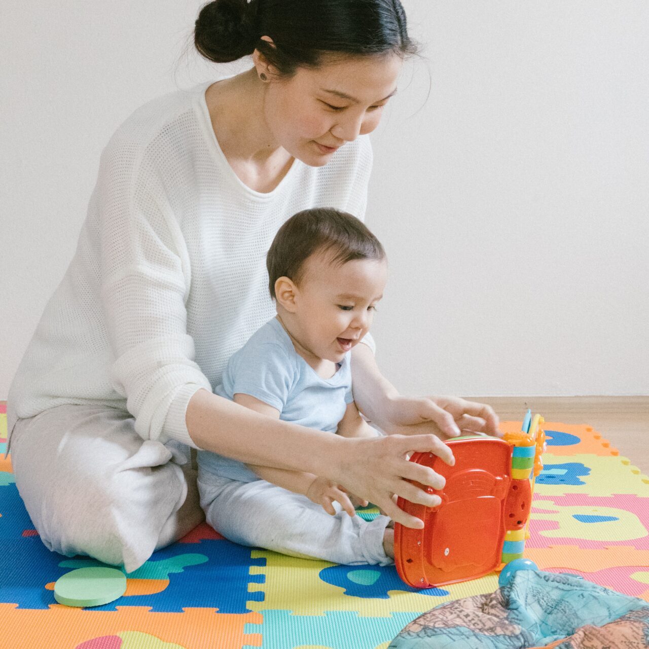 a mother and her son on a mat