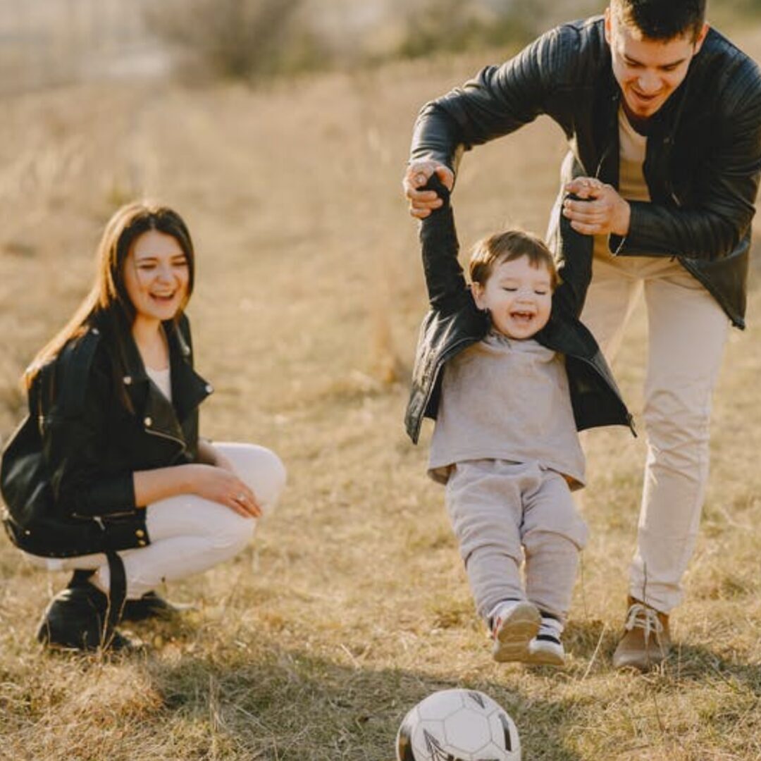 parents playing with their son